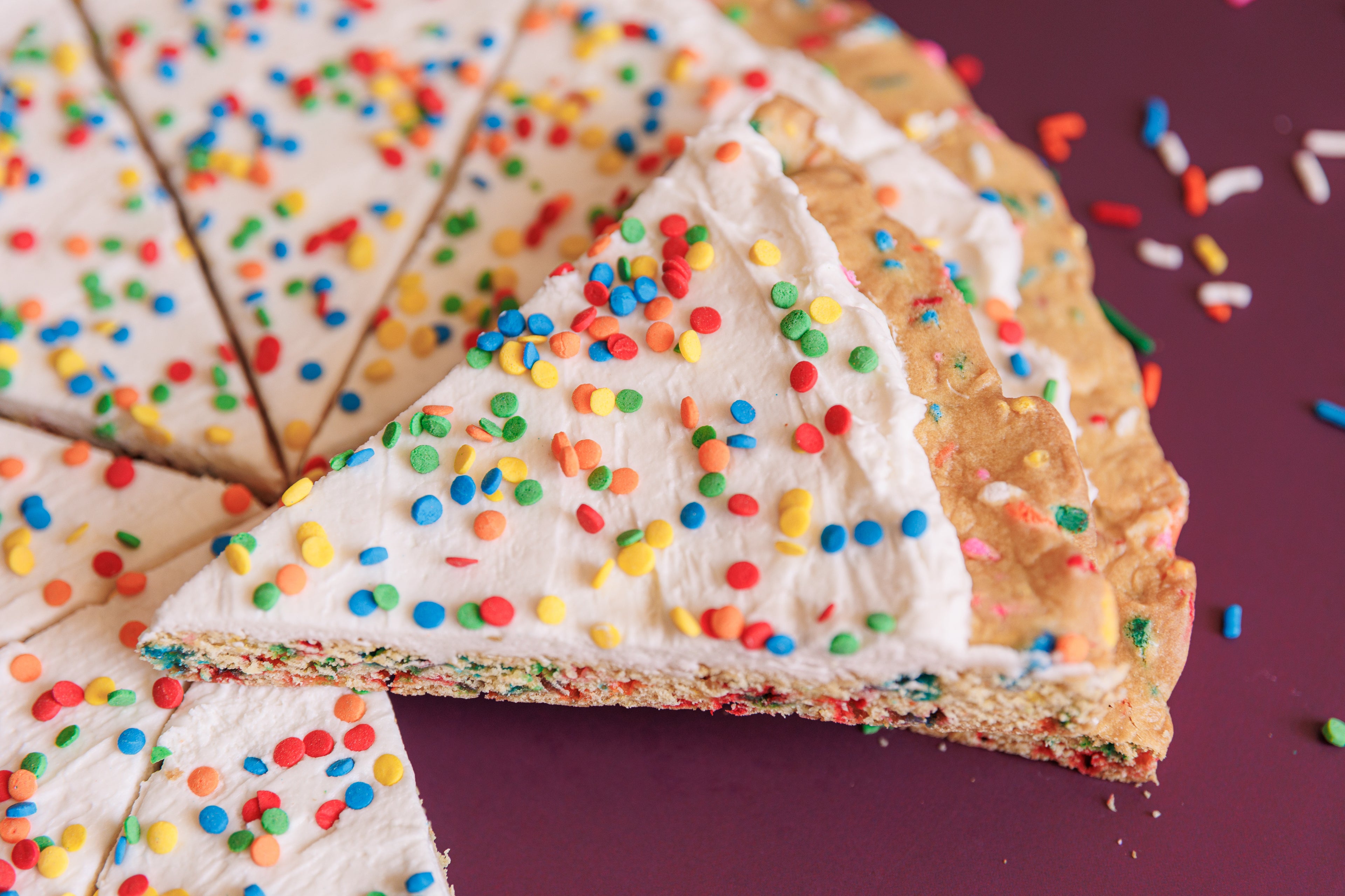 Close up slice of Funfetti of Destruction cookie pizza with birthday cake flavor